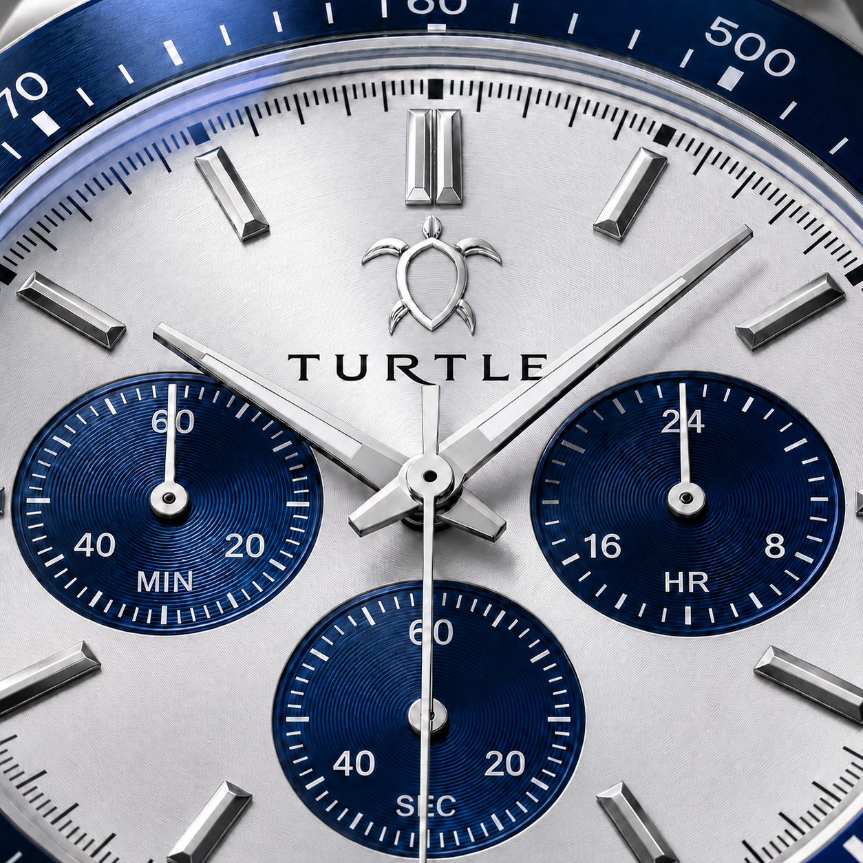 Macro view of the TURTLE dial and blue sub-dials